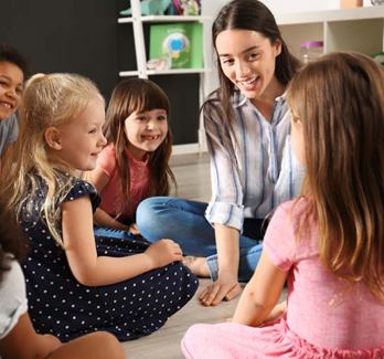 teacher and students on the floor in a classroom