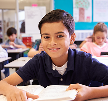 student at a desk in classroom