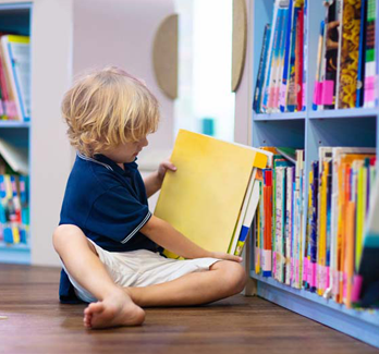 little boy in library